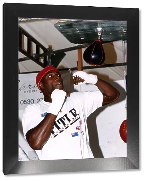 Frank Bruno boxer training with a speed ball