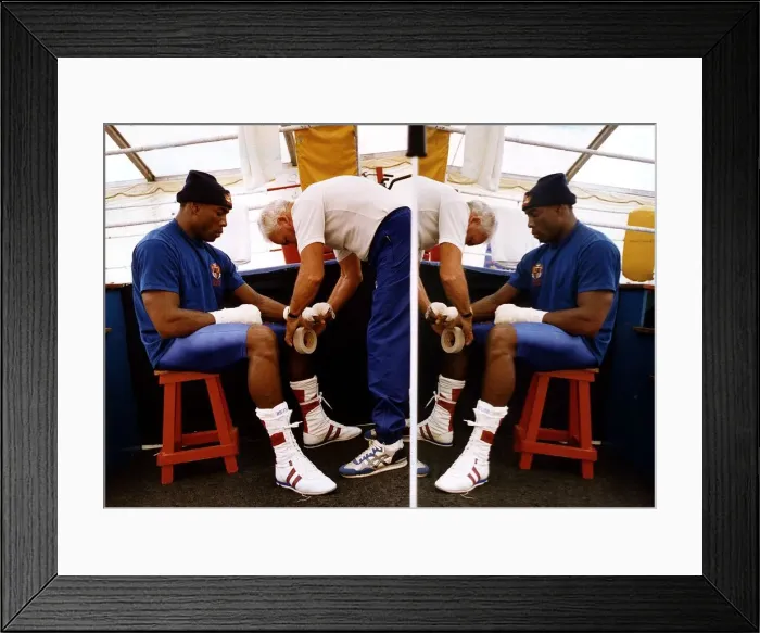 Framed Print : Frank Bruno Boxer sitting on stall having a bandage put on his hands