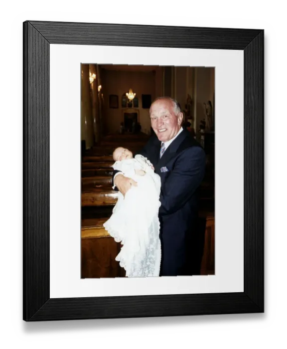 Framed Print : Henry Cooper, Boxing and Sports Personality holding his new grand child at Christening Framed Print : Henry Cooper, Boxing and Sports Personality holding his new grand child at Christening