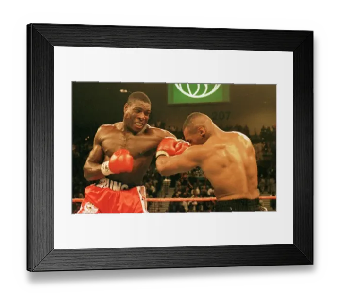 Framed Print : Frank Bruno lands a rare punch on Mike Tysons chin during the WBC world title fight in Framed Print : Frank Bruno lands a rare punch on Mike Tysons chin during the WBC world title fight in
