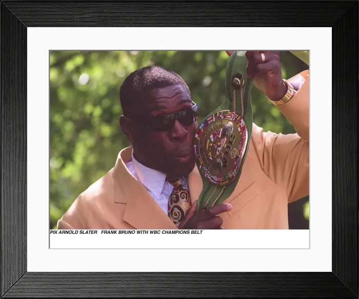 Framed Print : Frank Bruno holds up and kisses his WBC boxing championship belt the day after becoming Framed Print : Frank Bruno holds up and kisses his WBC boxing championship belt the day after becoming