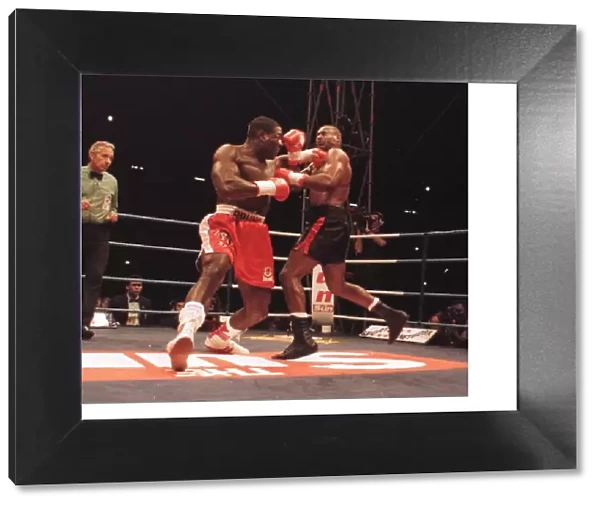 Frank Bruno lunges at Oliver McCall with a left Jab during their fight for