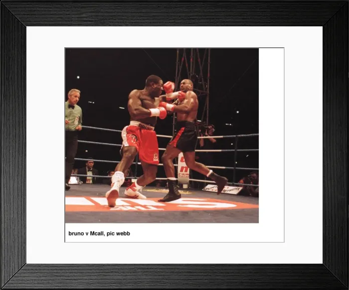 Framed Print : Frank Bruno lunges at Oliver McCall with a left Jab during their fight for Framed Print : Frank Bruno lunges at Oliver McCall with a left Jab during their fight for