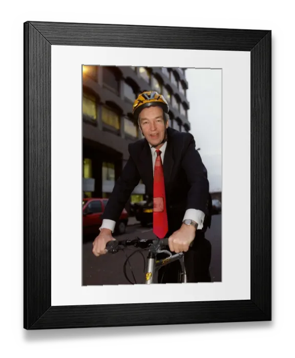 Framed Print : Jon Snow TV Presenter December 1998 Cahnnel 4 newscaster sitting on his pushbike