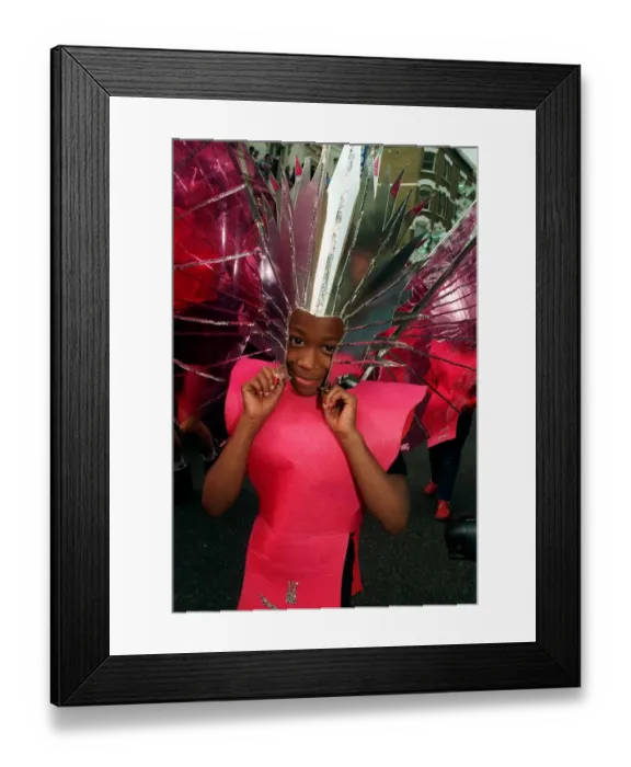 Framed Print : A girl celebrates the Notting Hill carnival in head dress and costume Framed Print : A girl celebrates the Notting Hill carnival in head dress and costume