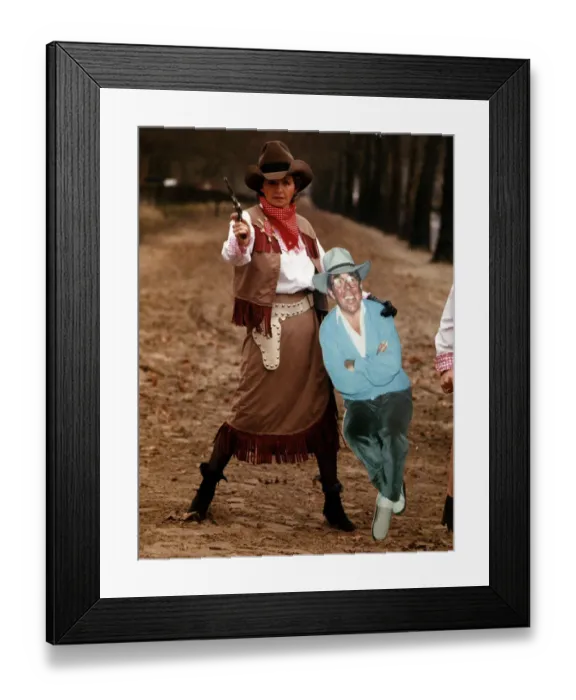 Framed Print : Sue Lawley TV Presenter dressed as a cowgirl with Hat and Gun holding a cardboard cutout