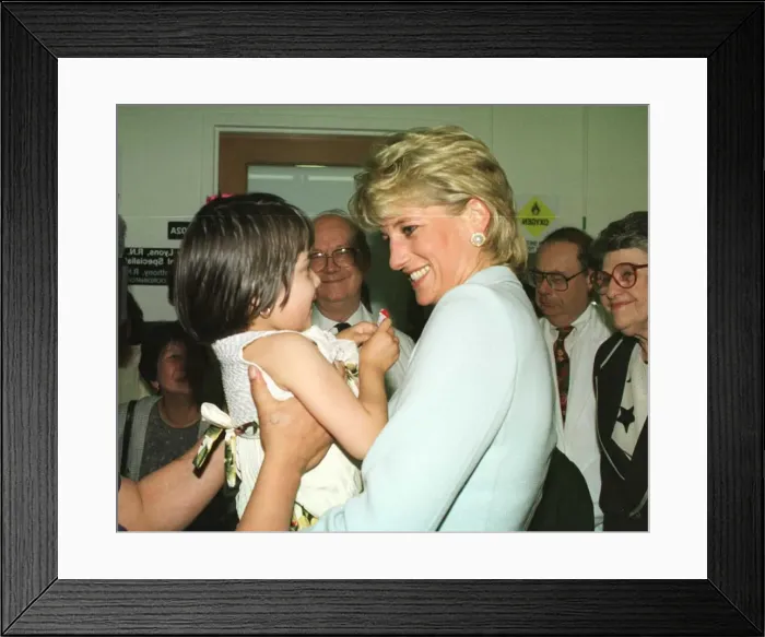 Framed Print : Diana, Princess of Wales, smiles as she holds a young girl at Cook County Hospital Framed Print : Diana, Princess of Wales, smiles as she holds a young girl at Cook County Hospital