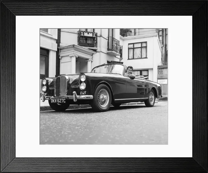 Framed Print : Tony Curtis, american actor poses for pictures in his Alvis TE21 motorcar in