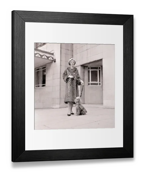 Framed Print : Fur coats for dogs - poodle and owner wearing matching fur coats September 1957 Framed Print : Fur coats for dogs - poodle and owner wearing matching fur coats September 1957
