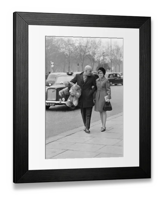 Framed Print : Actor Telly Savalas walking arm in arm in London with his wife, Marilynn Gardner Framed Print : Actor Telly Savalas walking arm in arm in London with his wife, Marilynn Gardner