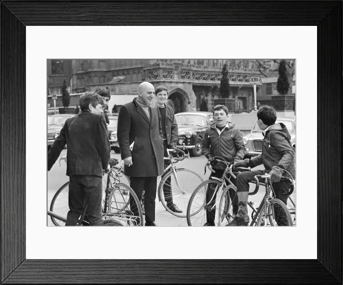 Framed Print : Actor Telly Savalas, surrounded by young fans with bikes