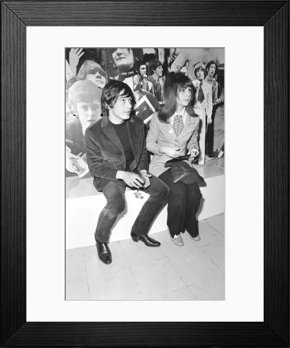 Framed Print : Christine Shrimpton with David Bailey. sitting in front of Photographic montage Framed Print : Christine Shrimpton with David Bailey. sitting in front of Photographic montage