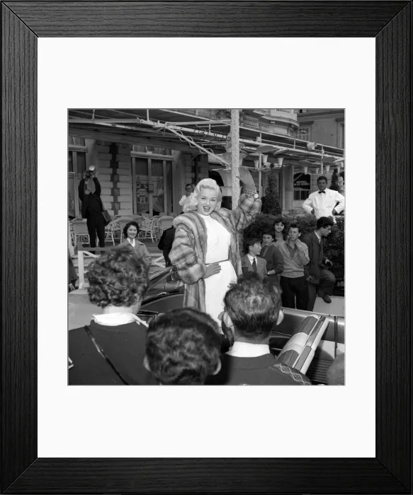 Framed Print : Actress Diana Dors waves to spectators and photographers on her arrival at the Cannes