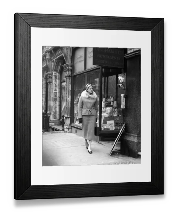Framed Print : Ingrid Bergman window shopping in Bond Street London wearing a fur trimmed tweed suit