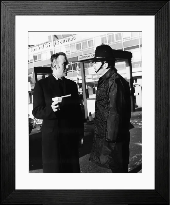 Framed Print : Christopher Lee pointing his Golden Gun'at a policeman after his arrival Framed Print : Christopher Lee pointing his Golden Gun'at a policeman after his arrival