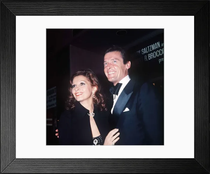 Framed Print : Roger Moore Actor and his wife Luisa at the premiere of the film The Man With The Golden Framed Print : Roger Moore Actor and his wife Luisa at the premiere of the film The Man With The Golden