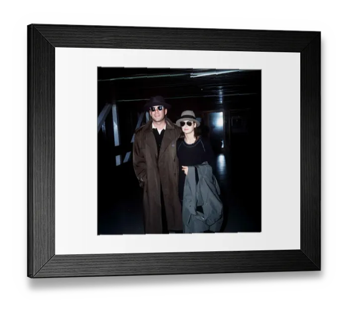 Framed Print : Bruce Willis with wife Demi Moore arriving at London Airport October 1987