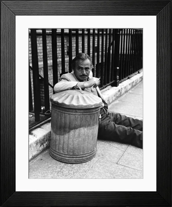 Framed Print : James Mason Actor leaning on a dustbin and fence