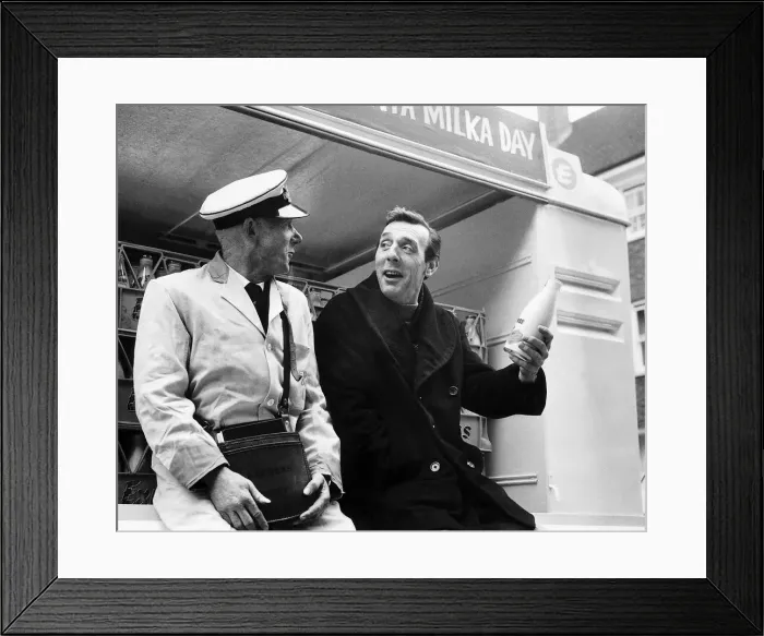 Framed Print : Eric Sykes Comedy Actor Comedian being shown by his milkman Harry Smith how its done
