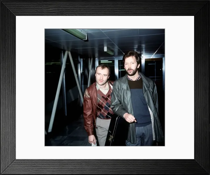 Framed Print : Phil Collins Singer Songwriter Actor with Eric Clapton leaving London Airport for