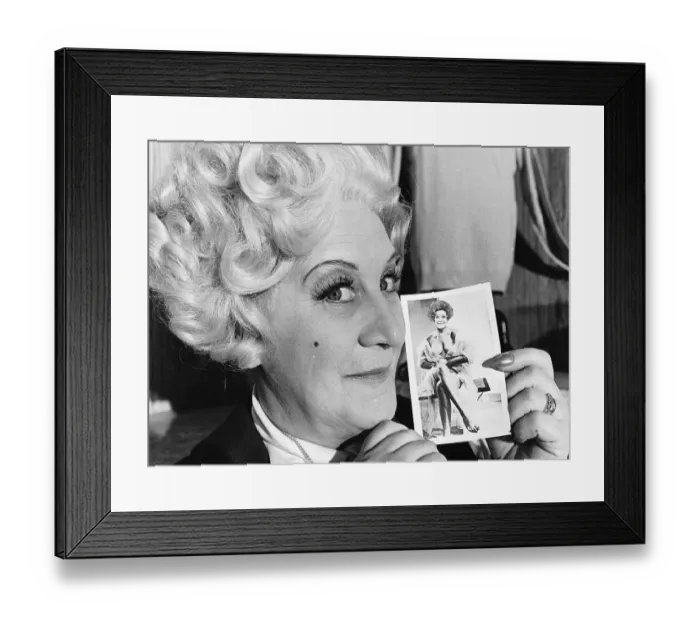 Framed Print : Mollie Sugden actress with a photo - July 1977 Appearing in the television