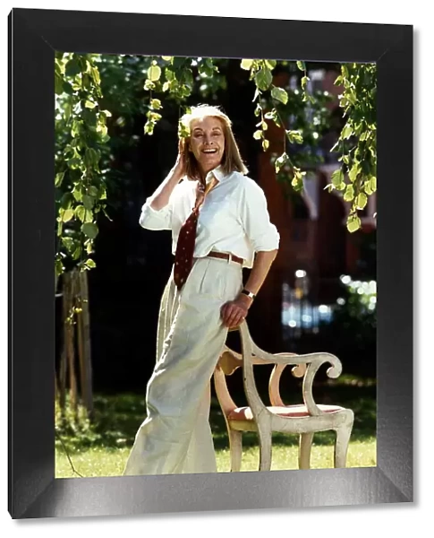 Jean Marsh actress standing in garden resting on back of chair, September 1989