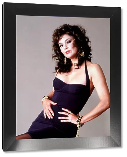 Marie Helvin Supermodel & Actress posing in a black halter neck low cut dress