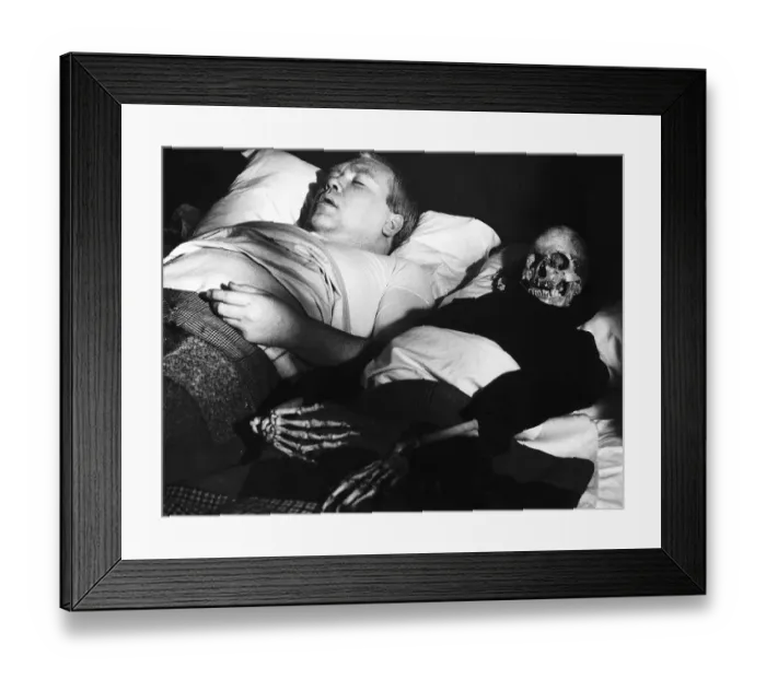Framed Print : Films Under Milk Wood starring in a scene is actor Ray Smith with his skeleton wife in Framed Print : Films Under Milk Wood starring in a scene is actor Ray Smith with his skeleton wife in