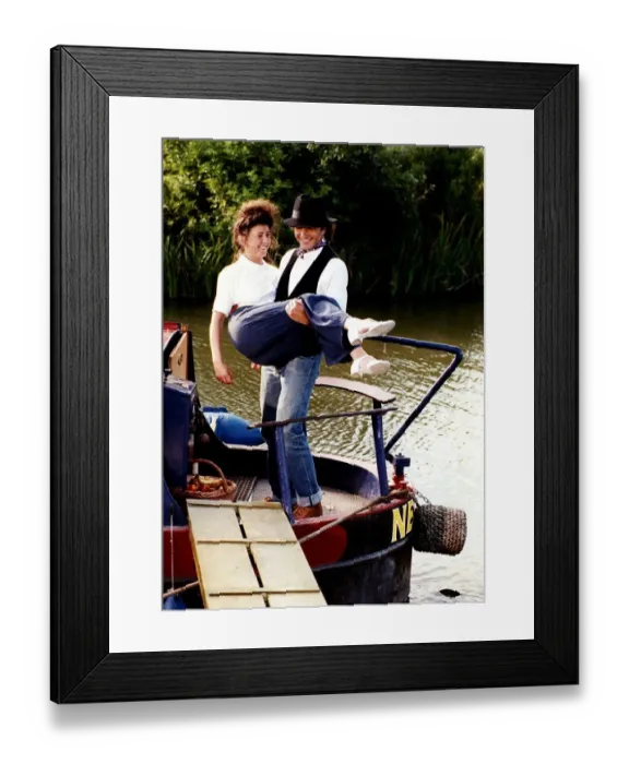 Framed Print : David Essex singer and actor on a barge boat carring a woman in a scene from his TV