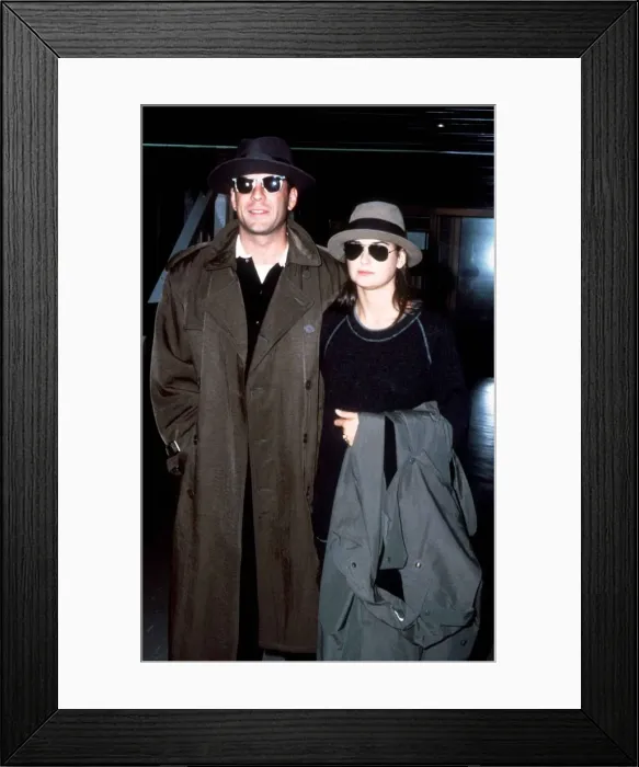 Framed Print : Bruce Willis with his wife Demi Moore pictured arriving at London Heathrow Airport Framed Print : Bruce Willis with his wife Demi Moore pictured arriving at London Heathrow Airport