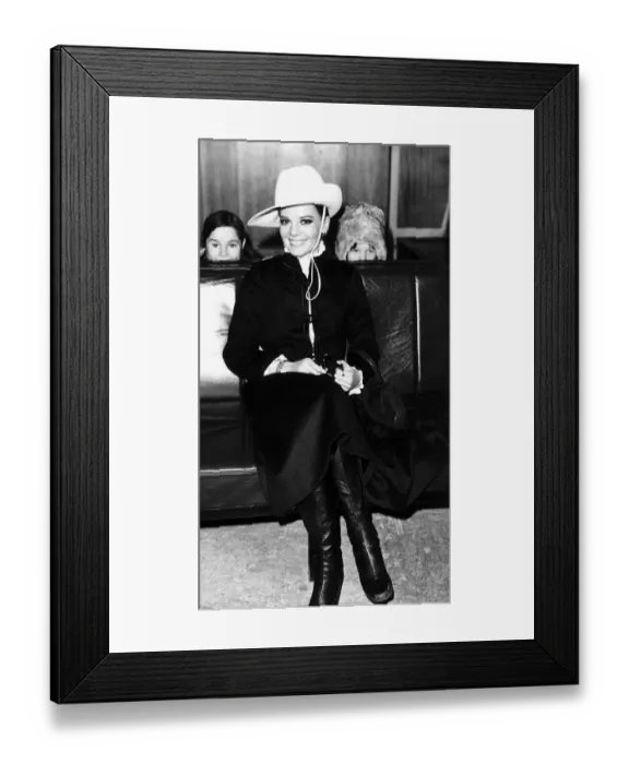 Framed Print : Natalie Wood waits for her flight at London airport peeping pver the seats are her Framed Print : Natalie Wood waits for her flight at London airport peeping pver the seats are her