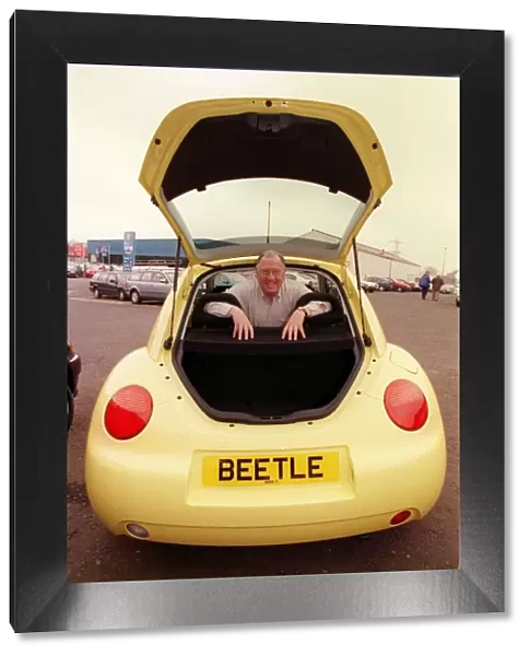 Comedian Andy Cameron April 1999 sitting inside a Volkswagen Beetle
