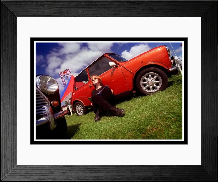Framed Print : Mini car August 1999 Woman sitting leaning against red Mini in the sun reading brochure Framed Print : Mini car August 1999 Woman sitting leaning against red Mini in the sun reading brochure
