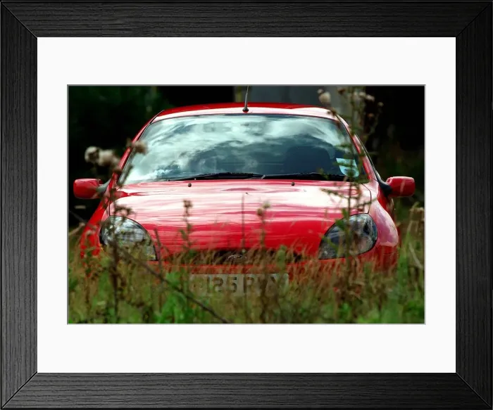 Framed Print : A RED FORD PUMA EXTERIOR PARKED IN GRASS AREA AUGUST 1997