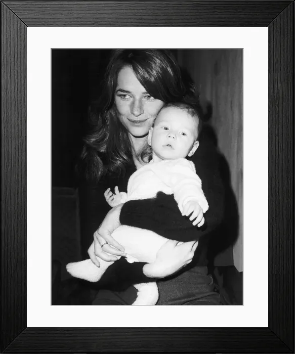 Framed Print : Charlotte Rampling - January 1973 At Heathrow Airport with her baby Barnaby Framed Print : Charlotte Rampling - January 1973 At Heathrow Airport with her baby Barnaby