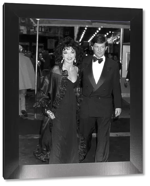 Joan Collins Actress walking arm in arm with her new man Malcolm Frazer