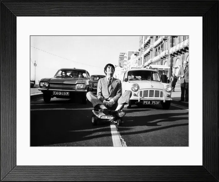 Framed Print : Derek Nimmo actor in Brighton riding a toy car dbase msi Framed Print : Derek Nimmo actor in Brighton riding a toy car dbase msi