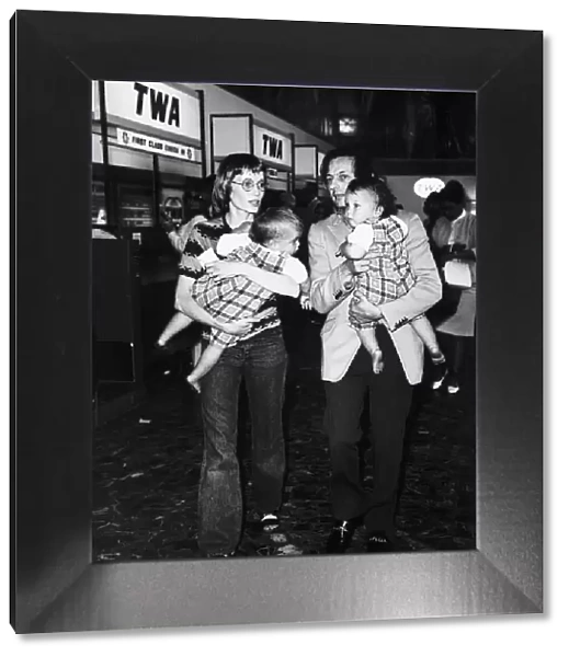 Mia Farrow Actress with husband and twin sons at Heathrow airport Dbase MSI