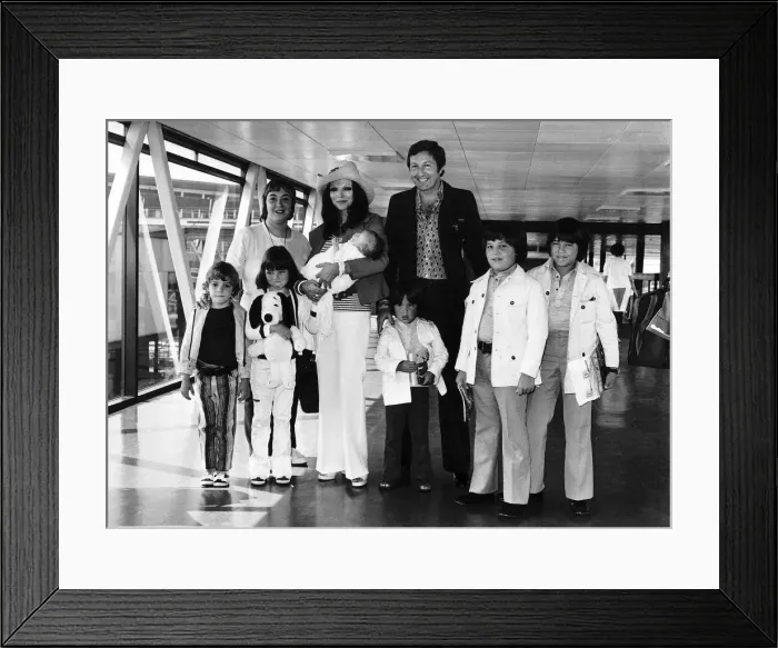 Framed Print : Joan Collins Actress with family at airport Dbase MSI