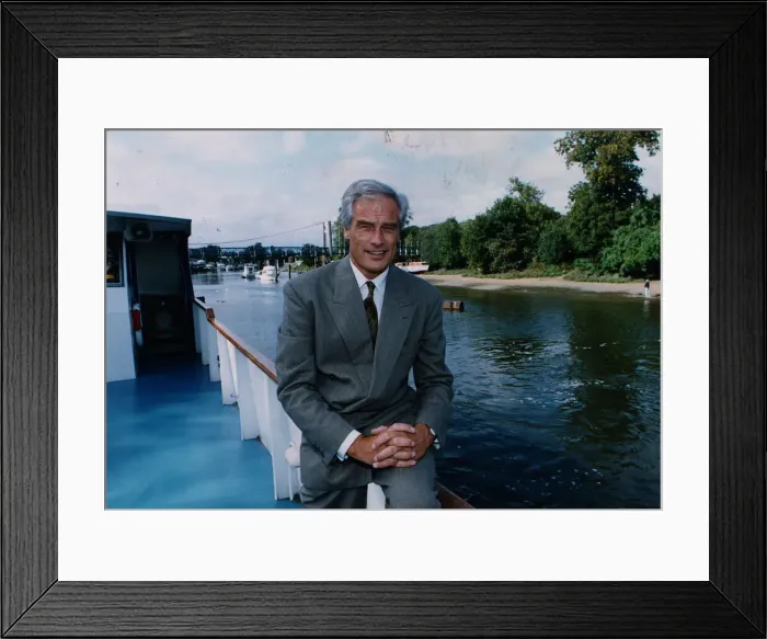 Framed Print : Robert Kilroy Silk former MP - TV Presenter on boat beside river grey suit