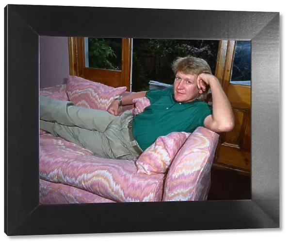 Mike Smith DJ disc jockey TV presenter lying lounging on couch settee sofa