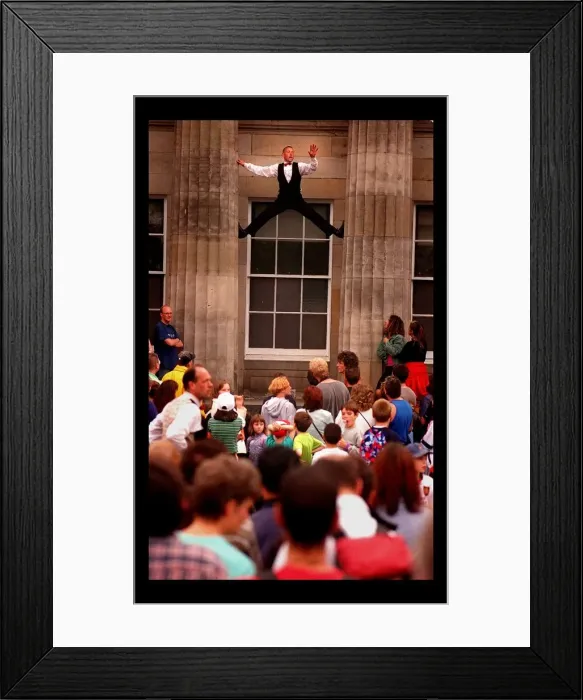Framed Print : Edinburgh Festival August 1998 man performer climbing up between two pillars Framed Print : Edinburgh Festival August 1998 man performer climbing up between two pillars