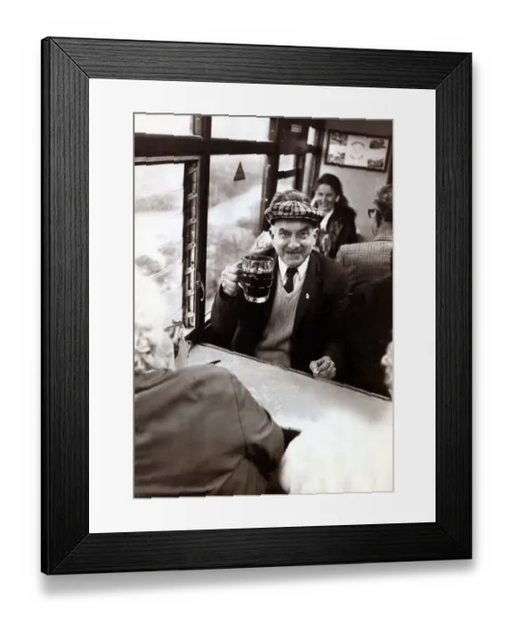 Framed Print : An elderley man enjoying a pint of beer on a Ffestiniog Railway train in North Wales