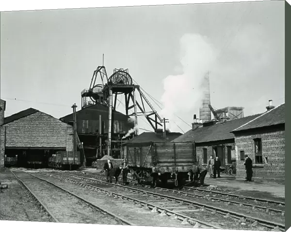 Worklers pulling along a wagon carrying coal at Priory Colliery in Blantyre
