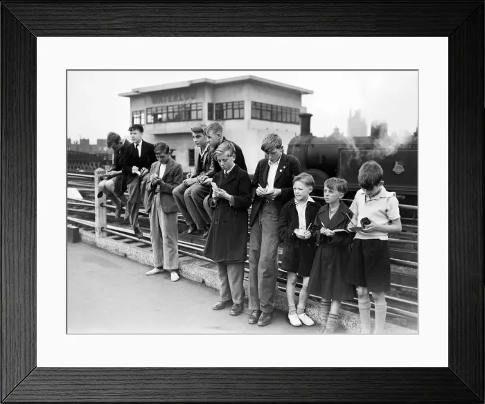 Framed Print : Trainspotters gather at the end of the platform at Waterloo station. August 1952 Framed Print : Trainspotters gather at the end of the platform at Waterloo station. August 1952