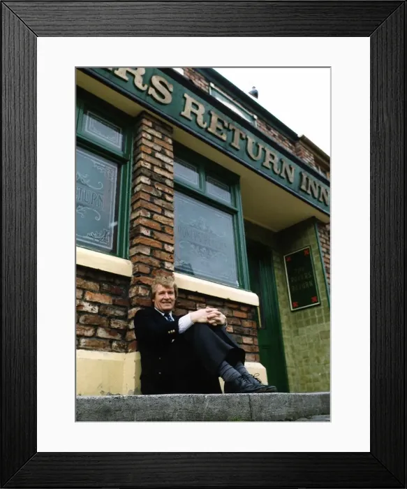 Framed Print : William Roache actor who plays Ken Barlow in tv programme Coronation Street outside pub