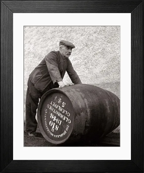 Framed Print : A Glenlivet Distillery worker in Scotland rolls a barrel of their finest single malt Framed Print : A Glenlivet Distillery worker in Scotland rolls a barrel of their finest single malt