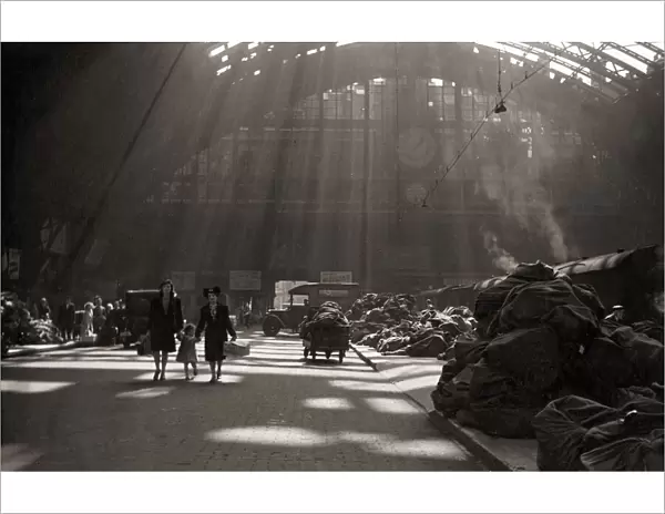 Sunlight filters through the roof of St. Pancras station London England during the war