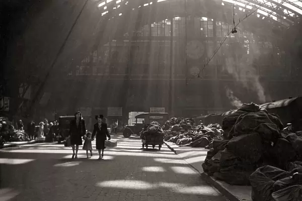 Sunlight filters through the roof of St. Pancras station London England during the war