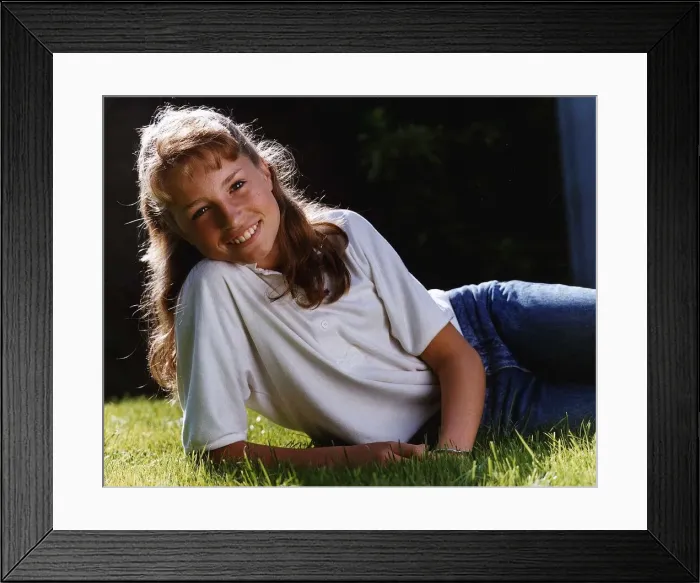 Framed Print : Juliette Carton actress wearing jeans lying in grass Framed Print : Juliette Carton actress wearing jeans lying in grass